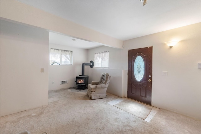 21410 161st Ave E, Graham, WA 98338 - carpeted foyer entrance featuring a wood stove
