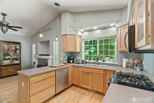 17943 Clear Lake Blvd SE, Yelm, WA 98597 - kitchen with stainless steel dishwasher, a sink, a peninsula, a ceiling fan, and light brown cabinets