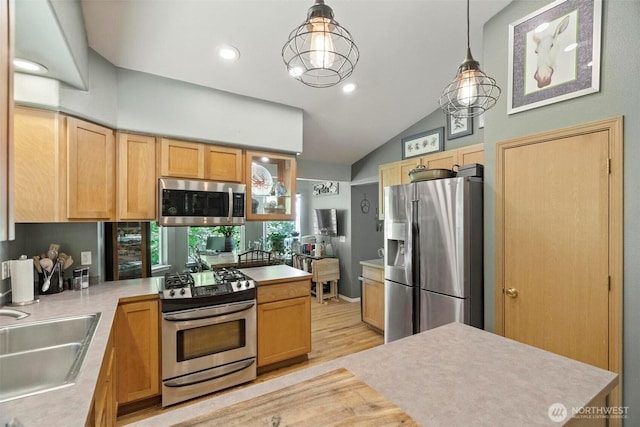 17943 Clear Lake Blvd SE, Yelm, WA 98597 - kitchen with appliances with stainless steel finishes, a sink, light countertops, a peninsula, and vaulted ceiling