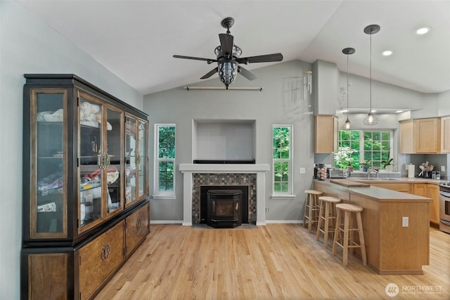 17943 Clear Lake Blvd SE, Yelm, WA 98597 - kitchen featuring vaulted ceiling, light wood-type flooring, ceiling fan, light brown cabinetry, and a breakfast bar