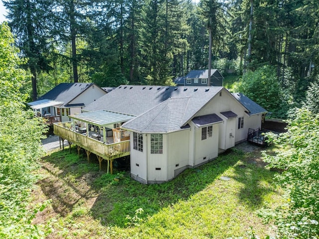 17943 Clear Lake Blvd SE, Yelm, WA 98597 - rear view of house featuring crawl space, roof with shingles, a deck, a view of trees, and a lawn