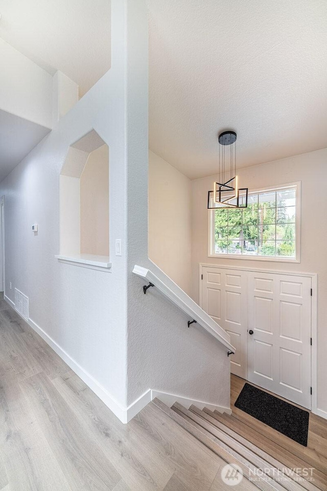8302 319th St NW, Stanwood, WA 98292 - foyer entrance featuring wood finished floors, baseboards, and a chandelier