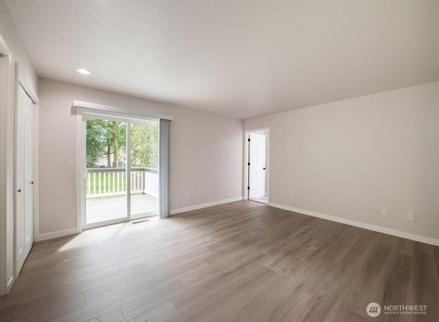 8302 319th St NW, Stanwood, WA 98292 - unfurnished room with wood finished floors, baseboards, and recessed lighting