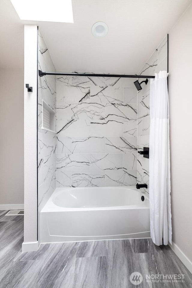 8302 319th St NW, Stanwood, WA 98292 - bathroom featuring shower / tub combo with curtain, baseboards, and wood finished floors