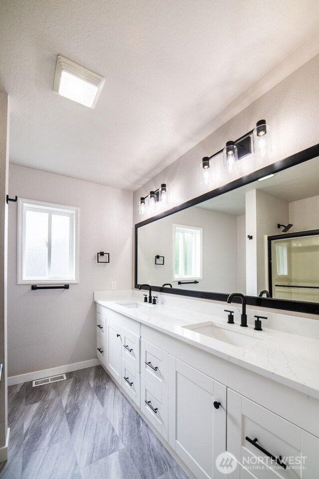 8302 319th St NW, Stanwood, WA 98292 - full bath featuring double vanity, baseboards, and marble finish flooring