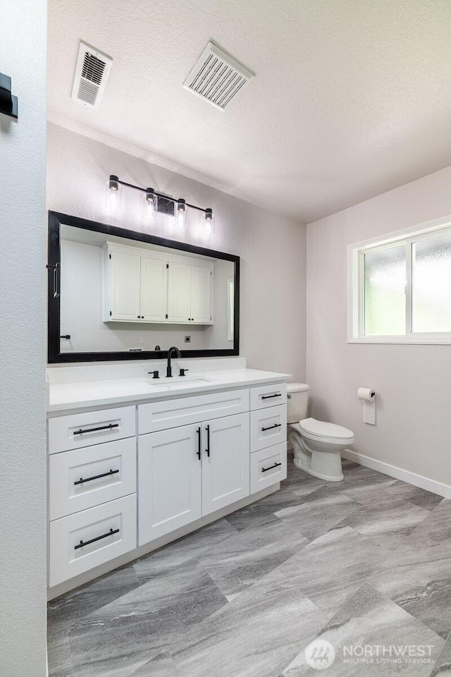 8302 319th St NW, Stanwood, WA 98292 - bathroom with toilet, vanity, and a textured ceiling