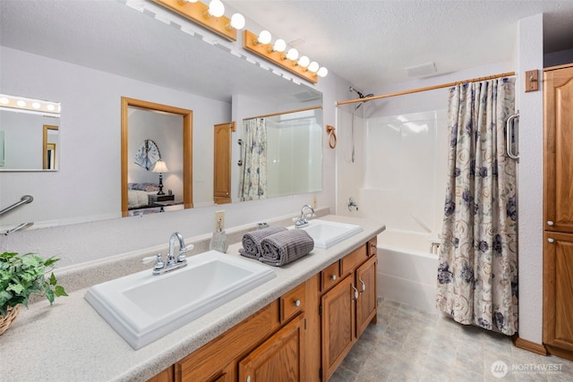 417 SW 116th St, Burien, WA 98146 - full bath with double vanity, shower / tub combo, and a textured ceiling