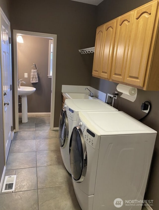 1809 Briarwood Pl, Wenatchee, WA 98802 - laundry area featuring cabinet space, separate washer and dryer, baseboards, and light tile patterned floors