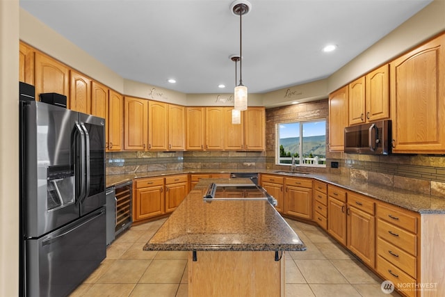 1809 Briarwood Pl, Wenatchee, WA 98802 - kitchen with stainless steel appliances, beverage cooler, a center island with sink, light tile patterned flooring, and tasteful backsplash