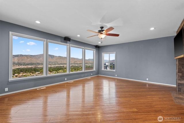 1809 Briarwood Pl, Wenatchee, WA 98802 - unfurnished room featuring a ceiling fan, a fireplace with flush hearth, wood finished floors, recessed lighting, and baseboards