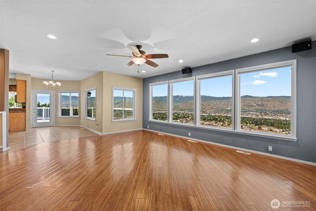 1809 Briarwood Pl, Wenatchee, WA 98802 - unfurnished living room featuring a chandelier, baseboards, a ceiling fan, and recessed lighting