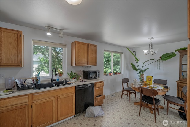 1722 Lincoln Park Cir, Wenatchee, WA 98801 - kitchen with black dishwasher, a sink, light countertops, and a chandelier