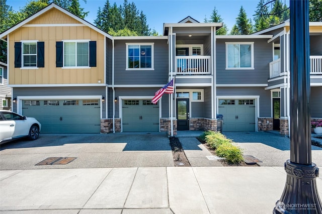 8605 E Gilman Ave, Arlington, WA 98223 - townhome / multi-family property with an attached garage, driveway, and stone siding