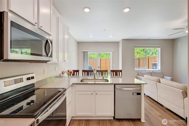 8605 E Gilman Ave, Arlington, WA 98223 - kitchen featuring stainless steel appliances, a peninsula, open floor plan, plenty of natural light, and recessed lighting