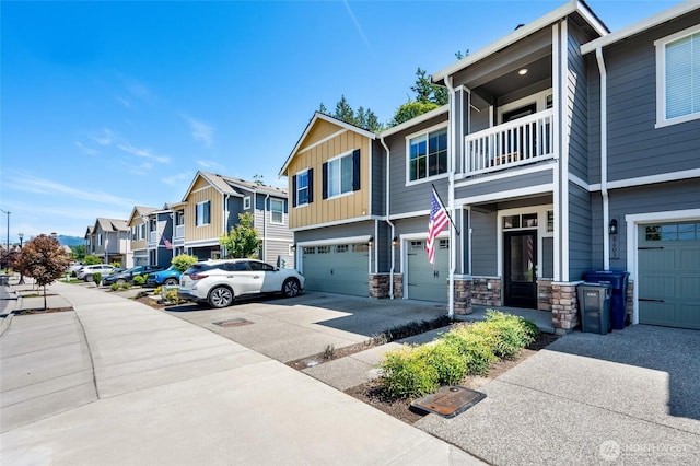 8605 E Gilman Ave, Arlington, WA 98223 - view of front facade with a residential view, a garage, board and batten siding, a balcony, and driveway