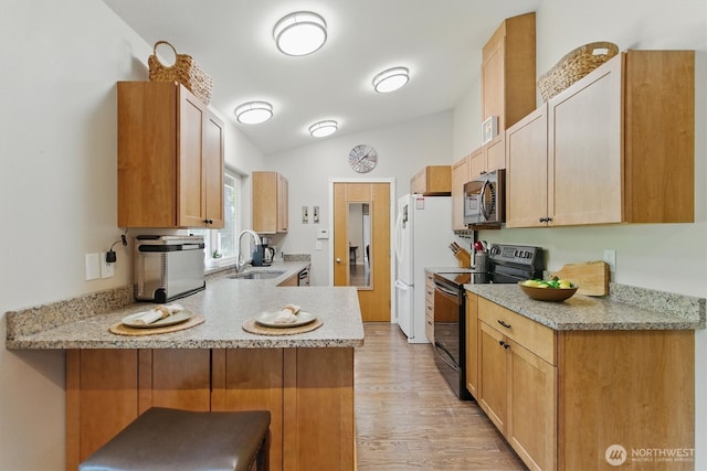 9264 Horizon Ln SE, Port Orchard, WA 98367 - kitchen featuring black / electric stove, a sink, a peninsula, stainless steel microwave, and light wood finished floors