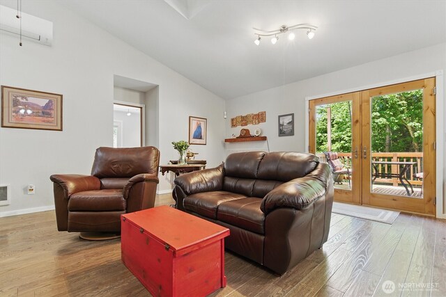 9264 Horizon Ln SE, Port Orchard, WA 98367 - living room featuring plenty of natural light, lofted ceiling, wood finished floors, and baseboards