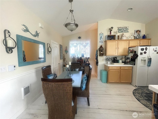 208 Taurus Blvd SW, Ocean Shores, WA 98569 - dining room featuring vaulted ceiling and light wood finished floors