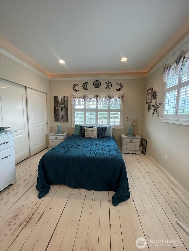 208 Taurus Blvd SW, Ocean Shores, WA 98569 - bedroom with ornamental molding, multiple windows, hardwood / wood-style floors, and a closet
