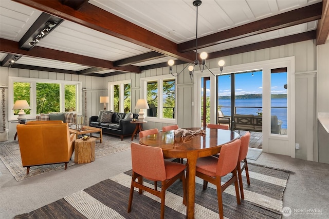 14830 Glen Acres Rd SW, Vashon, WA 98070 - dining area featuring carpet flooring, beamed ceiling, a water view, healthy amount of natural light, and a decorative wall