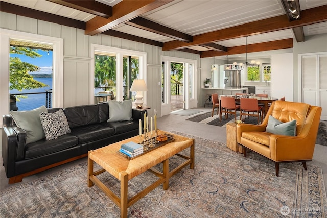 14830 Glen Acres Rd SW, Vashon, WA 98070 - living area with beam ceiling, healthy amount of natural light, carpet, a water view, and a chandelier