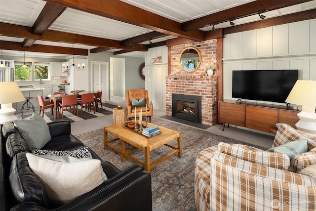 14830 Glen Acres Rd SW, Vashon, WA 98070 - living room featuring carpet, beam ceiling, a chandelier, and a fireplace