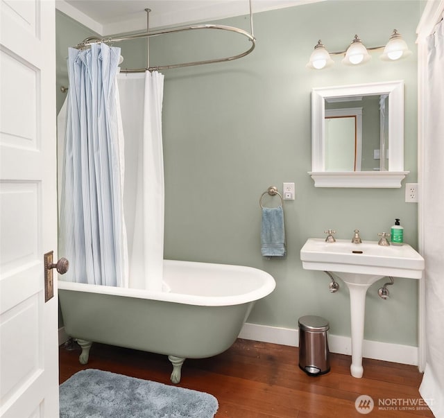 14830 Glen Acres Rd SW, Vashon, WA 98070 - full bath featuring wood finished floors, a freestanding tub, baseboards, a sink, and a shower with shower curtain