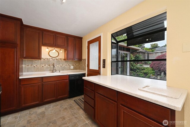 4245 Williams Ave W, Seattle, WA 98199 - kitchen featuring black dishwasher, a sink, light countertops, and backsplash