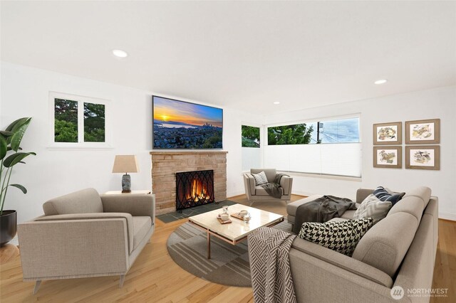 4245 Williams Ave W, Seattle, WA 98199 - living area featuring light wood-style floors, a stone fireplace, and recessed lighting
