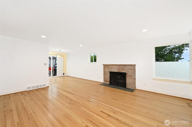 4245 Williams Ave W, Seattle, WA 98199 - unfurnished living room featuring light wood-style floors, a fireplace with flush hearth, recessed lighting, and baseboards