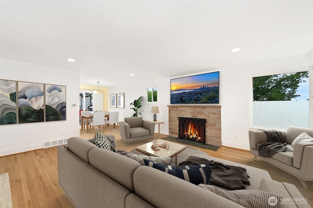 4245 Williams Ave W, Seattle, WA 98199 - living room with a fireplace with flush hearth, light wood finished floors, recessed lighting, and baseboards