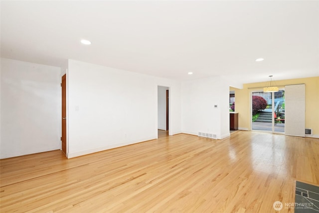 4245 Williams Ave W, Seattle, WA 98199 - empty room featuring light wood-type flooring, recessed lighting, and baseboards