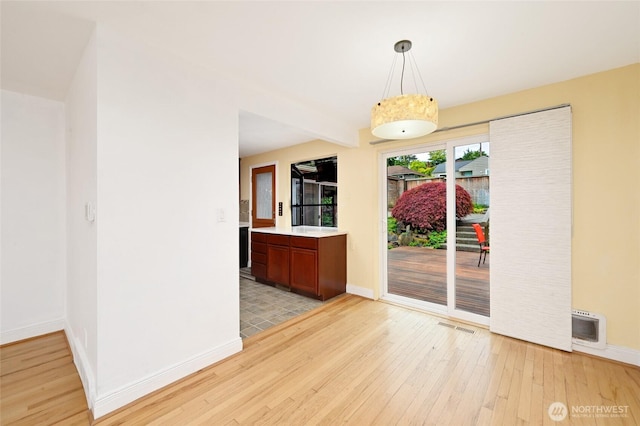4245 Williams Ave W, Seattle, WA 98199 - unfurnished dining area with light wood-style flooring and baseboards