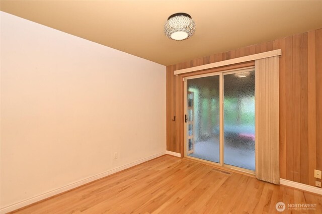4245 Williams Ave W, Seattle, WA 98199 - unfurnished room with wood finished floors, baseboards, and wooden walls