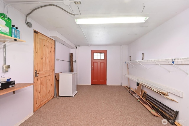 4245 Williams Ave W, Seattle, WA 98199 - basement with light colored carpet, refrigerator, and baseboards