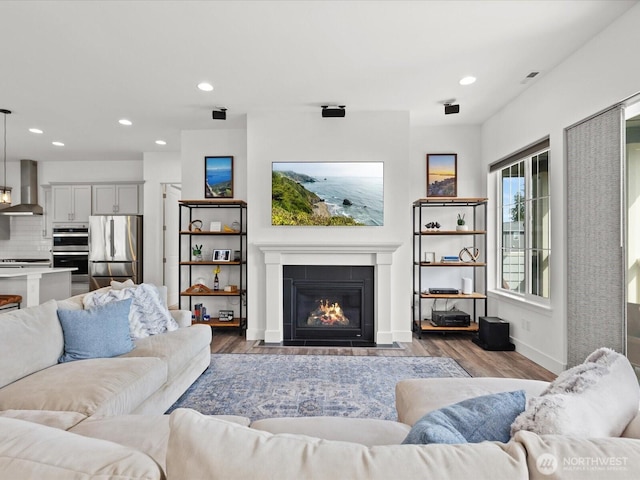 14505 117th St NE, Lake Stevens, WA 98258 - living room featuring recessed lighting, wood finished floors, a fireplace with flush hearth, and baseboards
