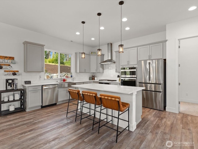 14505 117th St NE, Lake Stevens, WA 98258 - kitchen with stainless steel appliances, wall chimney exhaust hood, gray cabinetry, a sink, and light countertops