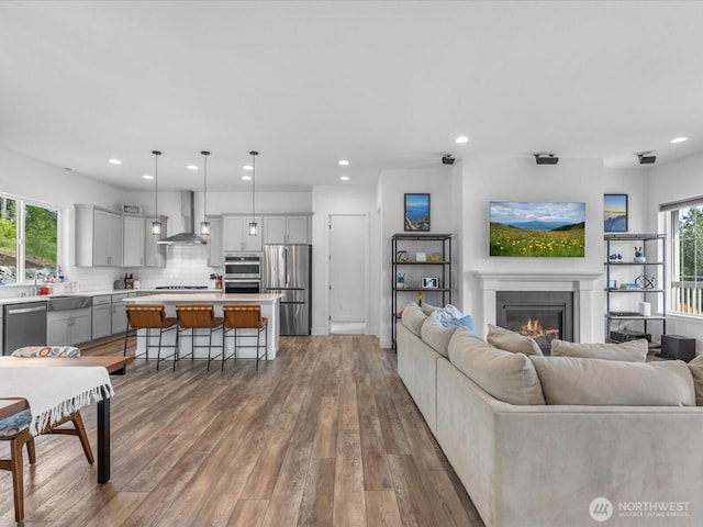 14505 117th St NE, Lake Stevens, WA 98258 - living area with recessed lighting, a glass covered fireplace, and wood finished floors