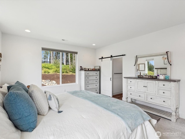 14505 117th St NE, Lake Stevens, WA 98258 - bedroom with a barn door, multiple windows, baseboards, and recessed lighting