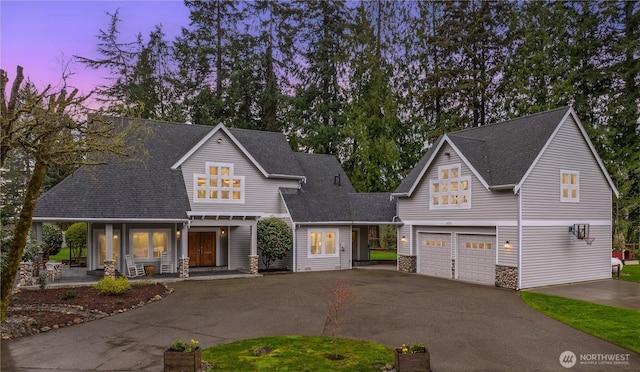 33025 129th Way SE, Auburn, WA 98092 - view of front of property with driveway, an attached garage, stone siding, a shingled roof, and a porch