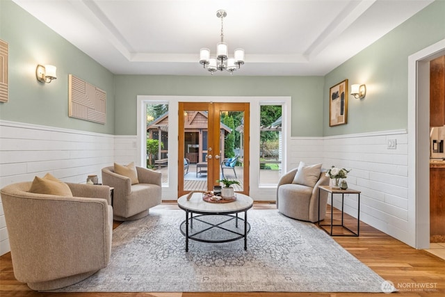 33025 129th Way SE, Auburn, WA 98092 - living area with a chandelier, a wainscoted wall, wood finished floors, a raised ceiling, and wooden walls