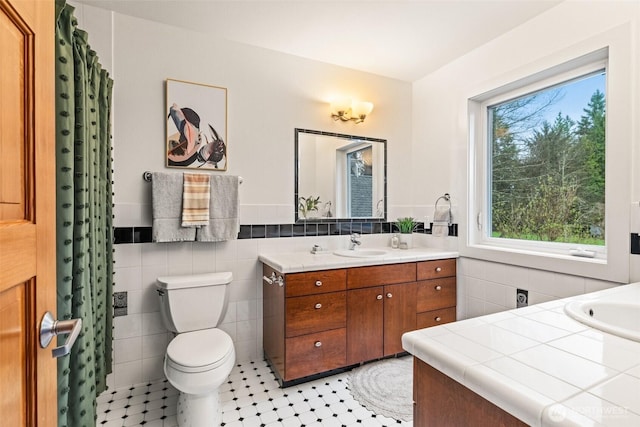 33025 129th Way SE, Auburn, WA 98092 - full bath with tile walls, vanity, toilet, tile patterned flooring, and a wainscoted wall