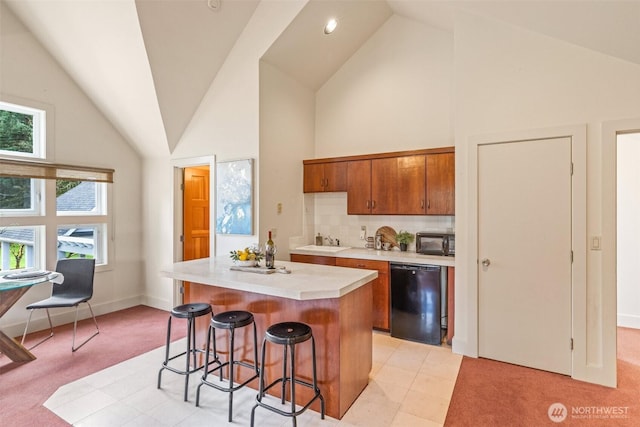 33025 129th Way SE, Auburn, WA 98092 - kitchen featuring black appliances, high vaulted ceiling, brown cabinetry, light countertops, and a kitchen bar