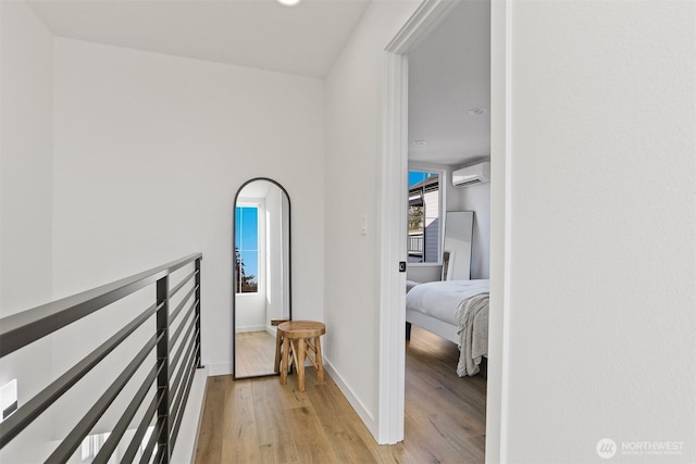 8757B Palatine Ave N, Seattle, WA 98103 - hallway with an AC wall unit, light wood finished floors, and baseboards