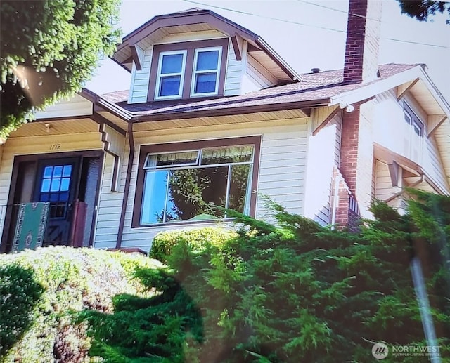 1712 30th Ave S, Seattle, WA 98144 - view of side of home featuring a chimney, roof with shingles, and a porch