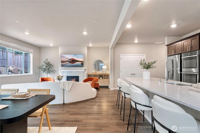 14126 SE 240th Pl, Kent, WA 98042 - living area featuring wood finished floors, recessed lighting, and a lit fireplace