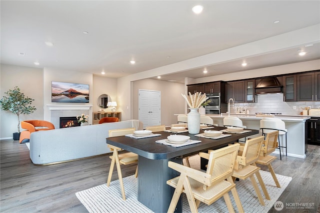 14126 SE 240th Pl, Kent, WA 98042 - dining space featuring light wood-style floors, recessed lighting, a tiled fireplace, and baseboards