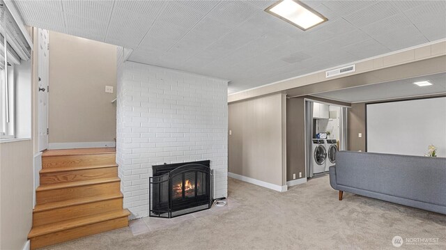 3953 153rd Ave SE, Bellevue, WA 98006 - living room with washing machine and clothes dryer, a brick fireplace, carpet floors, and stairway