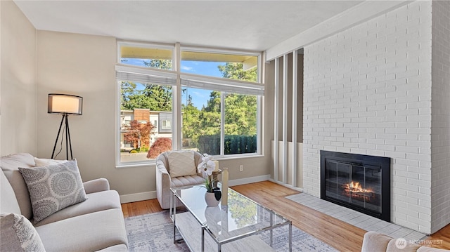 3953 153rd Ave SE, Bellevue, WA 98006 - living area featuring plenty of natural light, a brick fireplace, and baseboards