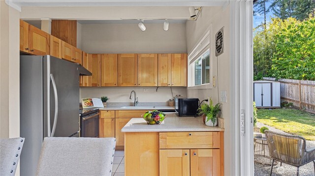 3953 153rd Ave SE, Bellevue, WA 98006 - kitchen featuring a sink, rail lighting, range with electric cooktop, freestanding refrigerator, and light countertops
